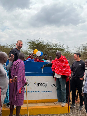 A village elder opens the tap for the first time.